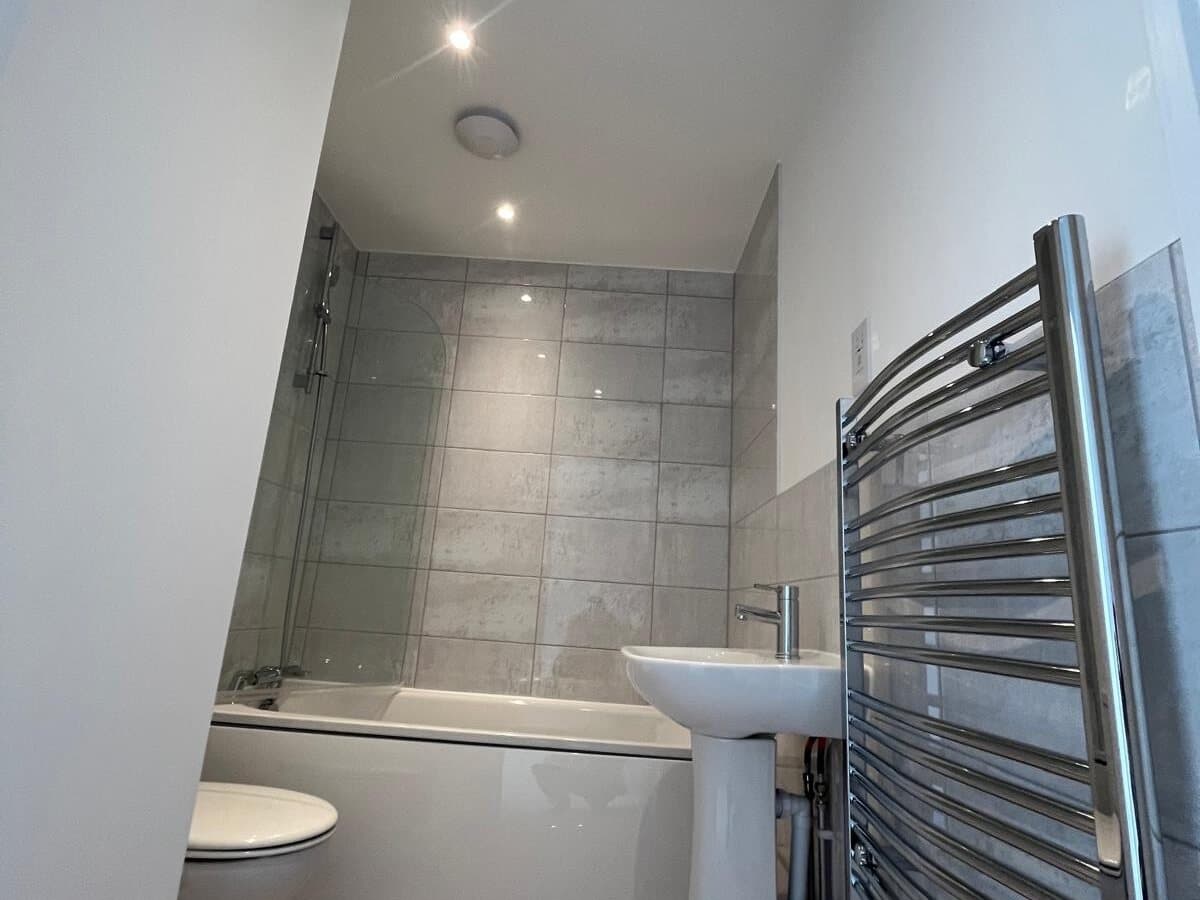 Bathroom with a heated towel rail and extractor fan