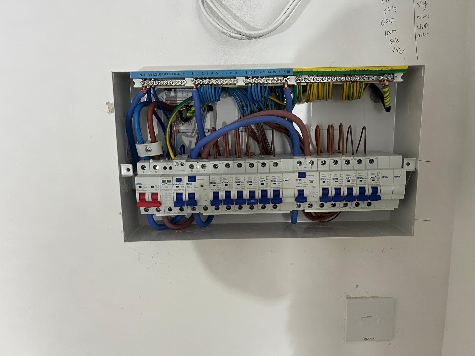 New consumer unit set flush into a white wall
