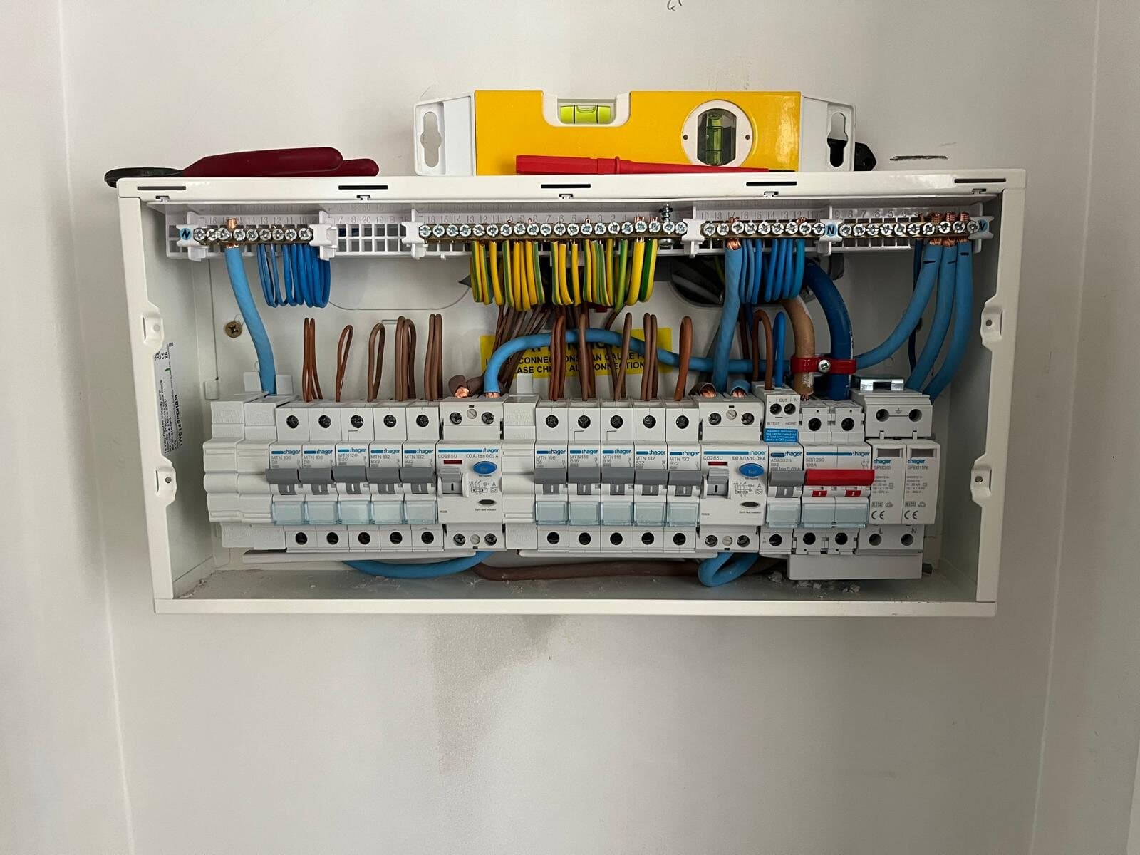 New consumer unit with the cover off on a painted wall