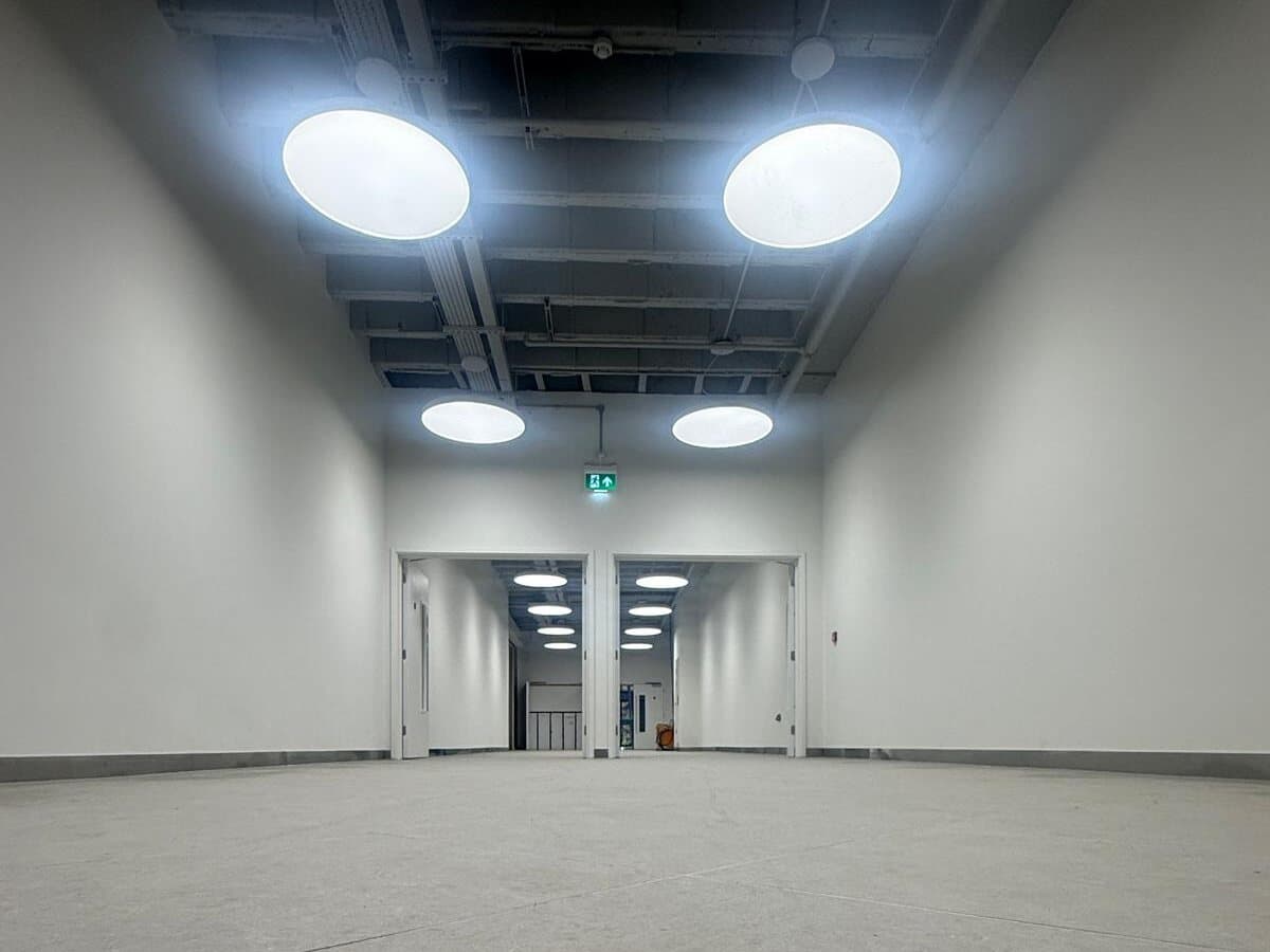Large round ceiling lights in an empty commercial unit