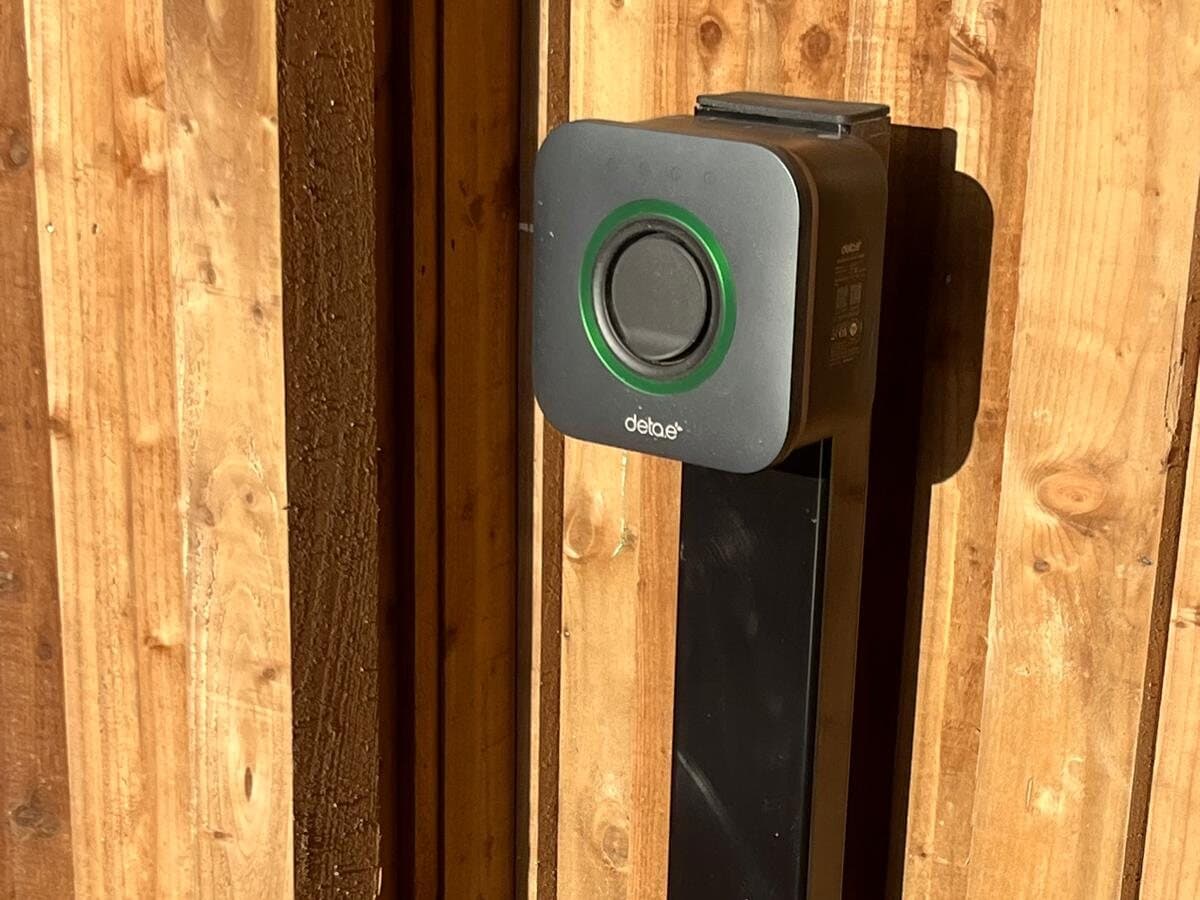 EV charger mounted on a post by a timber fence