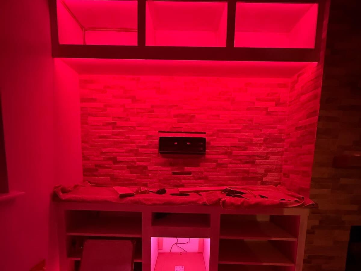 Alcove and shelves lit with red LED strip lighting