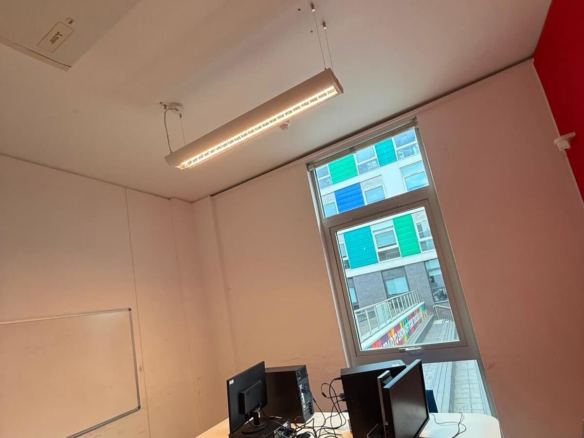 Office desk area with a new linear ceiling light