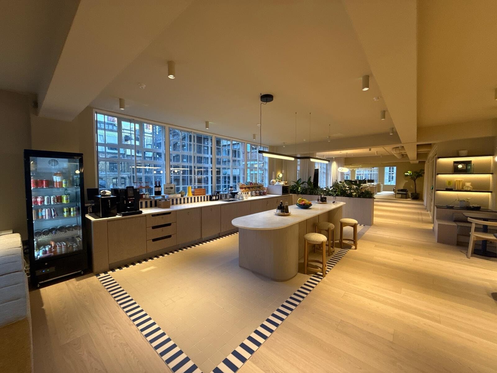 Office kitchen and breakout area with new pendant and strip lighting