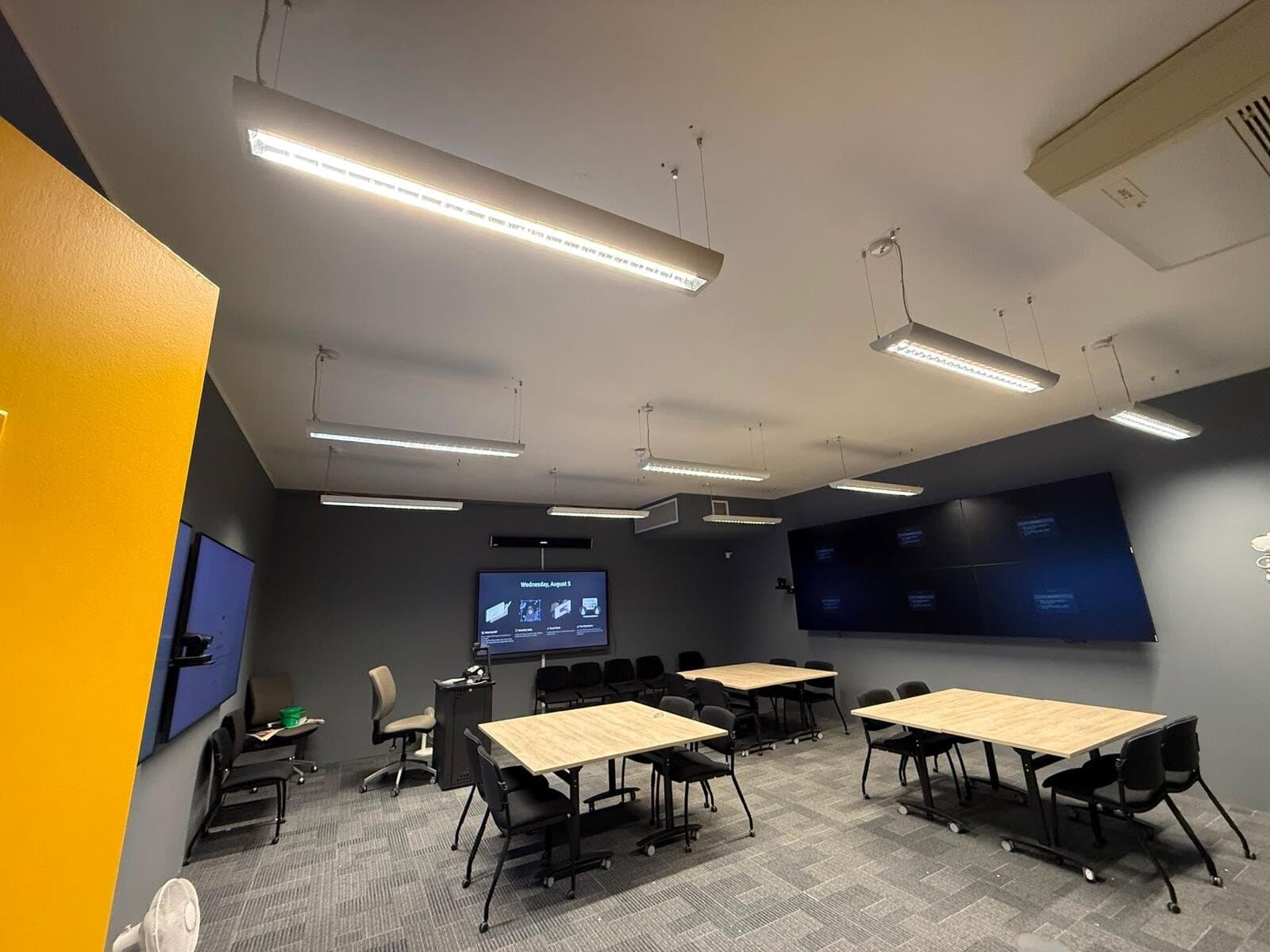 Open plan office lit with long linear lights