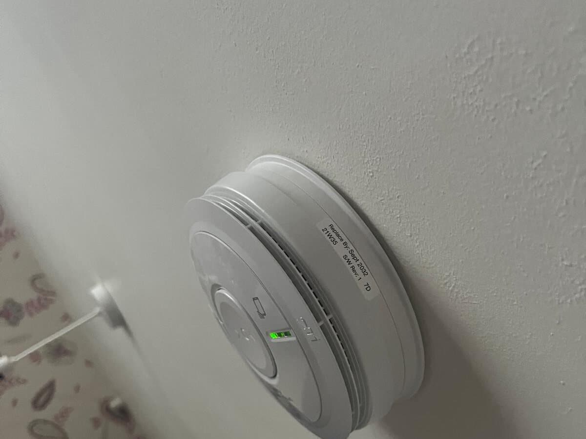 Mains smoke alarm fitted on a hallway ceiling